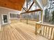 Spacious outdoor patio with wood flooring and wood railing overlooking the back yard at 2418 Lexington Approach Dr, Charlotte, NC 28262