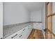 Spacious walk-in pantry with granite countertops, shaker cabinets, and hardwood floors at 2418 Lexington Approach Dr, Charlotte, NC 28262