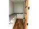 Walk-in pantry with granite countertops, wood floors, white cabinets and a clear door at 2418 Lexington Approach Dr, Charlotte, NC 28262