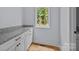 Walk-in pantry features ample cabinet space, granite countertops, and hardwood floors at 2418 Lexington Approach Dr, Charlotte, NC 28262
