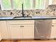 Modern kitchen sink with a dark countertop, new cabinets, and a patterned backsplash at 2418 Lexington Approach Dr, Charlotte, NC 28262