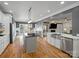 Open kitchen with modern appliances, hardwood flooring, view to the dining and living spaces, and abundant natural light at 2553 Cozy Cove Dr, York, SC 29745