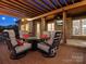 Relaxing outdoor patio with comfortable seating, mounted TV, and brick pillars at 2553 Cozy Cove Dr, York, SC 29745