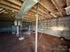 Unfinished basement with block walls offers potential for customization and additional living space at 32269 Pennington Rd, Albemarle, NC 28001
