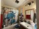 Bright bathroom with a turtle-themed shower curtain, framed mirror, and modern vanity at 32269 Pennington Rd, Albemarle, NC 28001