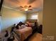 Cozy bedroom showcasing a ceiling fan, window, and comfortable bed dressed with plush bedding and pillows at 32269 Pennington Rd, Albemarle, NC 28001