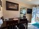 Classic dining room shows dark wood table and chairs leading to a view of the bright kitchen at 32269 Pennington Rd, Albemarle, NC 28001