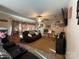 Cozy living room features a ceiling fan, television, and comfortable brown sofa with throws and pillows at 32269 Pennington Rd, Albemarle, NC 28001
