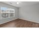 Bedroom features hardwood floors and natural light from the large window at 3553 Calpella Ct, Charlotte, NC 28262