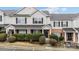 Inviting townhouse featuring a classic design, brick facade, manicured landscaping, and black shutters at 3553 Calpella Ct, Charlotte, NC 28262