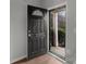 Entryway featuring a dark-colored door with house number above, and outside view from the screen door at 3553 Calpella Ct, Charlotte, NC 28262