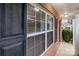 Close up view of the front window on the brick front porch with black shutters on a sunny day at 3553 Calpella Ct, Charlotte, NC 28262
