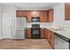 Kitchen featuring stainless steel appliances, modern countertops, and cherry wood cabinetry at 3553 Calpella Ct, Charlotte, NC 28262