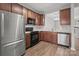Kitchen featuring stainless steel appliances, modern countertops, and cherry wood cabinetry at 3553 Calpella Ct, Charlotte, NC 28262