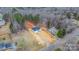 House and lot nestled among mature trees in a lush forest neighborhood from above at 3722 Thompson St, Newton, NC 28658