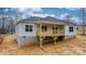 View of the back of the house with a walkout basement and wood deck at 3722 Thompson St, Newton, NC 28658