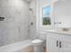 Modern bathroom featuring a walk-in shower, tiled walls, and white vanity at 3722 Thompson St, Newton, NC 28658