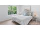 Serene bedroom featuring soft bedding, stylish side tables, and a calming view from a bright window at 3722 Thompson St, Newton, NC 28658