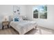 Bright bedroom featuring a cozy bed, neutral decor, and large window overlooking lush greenery at 3722 Thompson St, Newton, NC 28658