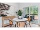 Modern dining area with round marble table, stylish chairs, and sliding doors to a private deck at 3722 Thompson St, Newton, NC 28658