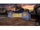 Charming one-story home featuring an attached garage and covered porch, set against a colorful sunset backdrop at 3722 Thompson St, Newton, NC 28658