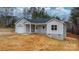 Home's front exterior with light gray siding, covered porch, and driveway at 3722 Thompson St, Newton, NC 28658