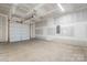 The unfinished garage is spacious with a white garage door and concrete floors at 3722 Thompson St, Newton, NC 28658