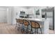 Well-lit kitchen boasts a large island with bar seating, stainless steel appliances, and sleek white cabinetry at 3722 Thompson St, Newton, NC 28658