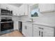 Modern kitchen with stainless steel appliances, white cabinets, and a sink under the window at 3722 Thompson St, Newton, NC 28658