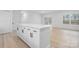 Bright kitchen features a large island with white cabinets and stainless steel hardware at 3722 Thompson St, Newton, NC 28658