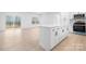 Modern kitchen featuring white cabinets, stainless steel appliances, and a spacious island with countertop seating at 3722 Thompson St, Newton, NC 28658