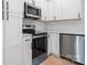 Modern kitchen featuring stainless steel appliances, white cabinets, and wood-look flooring at 3722 Thompson St, Newton, NC 28658