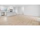 Open-concept living area with modern flooring, white kitchen cabinets, and stainless steel appliances at 3722 Thompson St, Newton, NC 28658