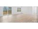Bright living room featuring sliding glass doors to the deck, a large window, and modern flooring at 3722 Thompson St, Newton, NC 28658