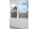 Large window showcasing the outdoor view of surrounding trees and neighborhood at 3722 Thompson St, Newton, NC 28658