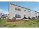 View of the home's backyard featuring a patio area with outdoor seating and a well-maintained lawn at 4228 Legacy Dr, Denver, NC 28037