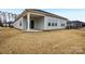 Exterior view of the home showcasing its backyard, covered patio, and neat landscaping at 4919 Trigney Ct, Charlotte, NC 28214