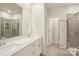 Bathroom with double sink vanity and glass enclosed shower at 4919 Trigney Ct, Charlotte, NC 28214