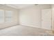 Bright bedroom features neutral carpet, large windows, and a modern, minimalist design at 4919 Trigney Ct, Charlotte, NC 28214
