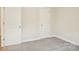 Clean, neutral bedroom boasts new carpet and two bright white doors at 4919 Trigney Ct, Charlotte, NC 28214