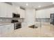 Stylish kitchen showcasing stainless steel appliances, granite countertops, and ample cabinet space at 4919 Trigney Ct, Charlotte, NC 28214