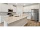 Kitchen featuring a large island with a sink, stainless appliances, and ample counter space at 4919 Trigney Ct, Charlotte, NC 28214