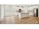 Open kitchen with stainless steel appliances, white cabinets, and a large island at 4919 Trigney Ct, Charlotte, NC 28214