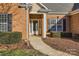 Charming brick home exterior with manicured landscaping, including lush bushes, enhancing curb appeal and welcoming entrance at 5114 Keels Ct, Charlotte, NC 28269