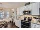 Open kitchen area with modern appliances, granite countertops, and breakfast nook at 5114 Keels Ct, Charlotte, NC 28269