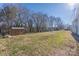 View of the backyard with the lawn, some trees, and a shed at 528 6Th St, Chester, SC 29706