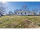 Exterior home view showing a grassy backyard with mature trees at 528 6Th St, Chester, SC 29706