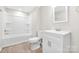 Bathroom featuring a white vanity, toilet, and bathtub with updated flooring and neutral paint at 528 6Th St, Chester, SC 29706