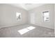 Light filled bedroom with neutral carpet and paint and two large windows and a door at 528 6Th St, Chester, SC 29706
