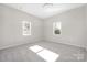 Bright bedroom with plush carpet, neutral walls, and natural light from two windows at 528 6Th St, Chester, SC 29706